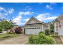 Well-maintained single-story home with a manicured lawn and a spacious two-car garage at 113 Dowington Ln, Cary, NC 27519