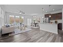 Open concept living room, dining room and kitchen with lots of light and modern furniture at 1136 Longitude Dr, Durham, NC 27713
