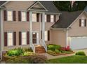 Charming two-story home with a landscaped front yard, inviting entrance, and attached garage at 12325 Amoretto Way, Raleigh, NC 27613