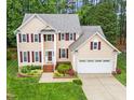 Attractive two-story home with landscaped front yard, driveway, attached garage, and inviting entryway at 12325 Amoretto Way, Raleigh, NC 27613