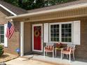 Close up of a cozy front porch with seating and charming details at 1290 Pyrtle Dr, Graham, NC 27253