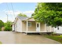 Charming home exterior with a covered front porch, clean lines, and ample parking on the paved driveway at 1309 Jackson St, Burlington, NC 27217
