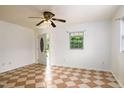 Bright living room featuring a ceiling fan, tiled floors and a front door leading to a porch at 1309 Jackson St, Burlington, NC 27217