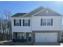 Two-story home with white siding, black shutters, and a two-car garage at 132 Rockfall Way, Rocky Mount, NC 27803