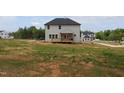 Spacious backyard featuring a wooden deck and exterior view of the two-story home at 1406 Reading Ct # 93 Kl, Burlington, NC 27217