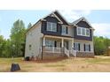 Attractive two-story home with a covered porch, white railing, and manicured lawn at 1406 Reading Ct # 93 Kl, Burlington, NC 27217