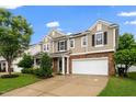 Well-maintained two-story home with a large driveway, tidy lawn, and a side-entry two-car garage at 149 Cinder Cross Way, Garner, NC 27529