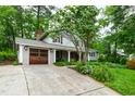 A picturesque home exterior with a beautiful lawn and garden, a classic design, and a convenient driveway at 1513 Dellwood Dr, Raleigh, NC 27607