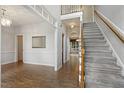 Bright foyer with hardwood floors, staircase, and view into other rooms at 1601 Castalia Dr, Cary, NC 27513