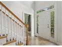 Inviting foyer with natural light, staircase, and view of the front door at 1601 Castalia Dr, Cary, NC 27513