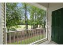 Balcony showcasing green trees and a grassy view in a peaceful outdoor setting at 1723 Kudrow Ln, Morrisville, NC 27560