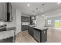 Modern kitchen with stainless steel appliances, granite countertops, and a center island at 19 Willow Green Dr, Clayton, NC 27527