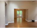 Open floor plan showcasing hardwood floors and a large window providing a view of the outdoors at 200 W Woodcroft Pkwy # 52A, Durham, NC 27713