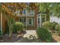 Close-up of front porch with brick steps and landscaped walkway leading to home entrance at 2030 Prairie Ridge Ct, Fuquay Varina, NC 27526