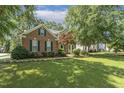 Brick home with well-maintained lawn and landscaping in a residential neighborhood at 2030 Prairie Ridge Ct, Fuquay Varina, NC 27526