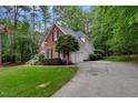 Side exterior of home with well-maintained lawn and concrete driveway at 204 Middlestone Ct, Wake Forest, NC 27587