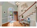 Grand foyer with hardwood floors, staircase, and an arched window with lots of light at 204 Middlestone Ct, Wake Forest, NC 27587