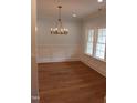 Light-filled dining room with hardwood floors and traditional wainscoting at 2112 Coy St, Burlington, NC 27215