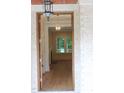 Home entryway featuring hardwood floors, white trim, and an elegant hanging lantern at 2112 Coy St, Burlington, NC 27215