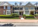 Charming townhome with a manicured lawn, brick accents, and a welcoming front porch with brick steps at 2503 Saint Pauls Sq, Raleigh, NC 27614