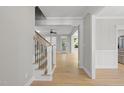 Inviting foyer showcasing beautiful hardwood floors and elegant staircase at 2721 Cameron Pond Dr, Cary, NC 27519