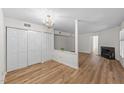 Spacious living room featuring laminate flooring, a fireplace, and ample closet space at 2821 Edridge Ct, Raleigh, NC 27612