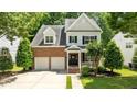 Two-story brick home with attached two-car garage, manicured lawn, and inviting front entrance at 303 Middleham Dr, Rolesville, NC 27571