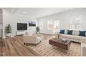 Bright, neutral living room with hardwood floors, contemporary furniture, a media center, and lots of natural light at 3101 Brellon Ln, Durham, NC 27703