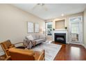 Bright living room with a cozy fireplace, hardwood floors, and neutral decor, perfect for relaxation and entertainment at 33 Grapevine Trl, Durham, NC 27707