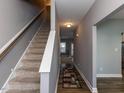 Bright hallway with staircase and hardwood floors, creating a welcoming and stylish entrance at 333 Bald Head Island Dr, Garner, NC 27529