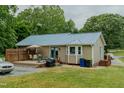 Back of home featuring a well-maintained backyard deck perfect for relaxing or entertaining at 403 Rolling Rd, Haw River, NC 27258