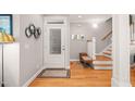 Welcoming entryway with hardwood floors, a staircase, and stylish decorations at 404 S Camellia St, Chapel Hill, NC 27516