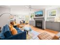 Bright living room featuring a fireplace, hardwood floors, and modern furniture at 404 S Camellia St, Chapel Hill, NC 27516