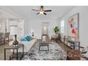 Open-concept living room filled with natural light, modern décor, and stylish furniture at 428 Longleaf Glen Lane, Zebulon, NC 27597