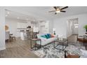 Open-concept living room flowing into a kitchen with white cabinets and modern decor at 428 Longleaf Glen Lane, Zebulon, NC 27597