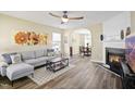 Inviting living room featuring a fireplace, hardwood floors, and an open archway to dining at 4508 Cobble Creek Ln, Raleigh, NC 27616