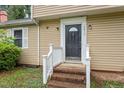Inviting entrance showcasing the front door with white trim and brick steps at 4812 Kaplan Dr, Raleigh, NC 27606