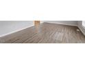 Bright living room featuring modern vinyl floors and fresh paint at 4812 Kaplan Dr, Raleigh, NC 27606
