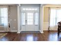 Elegant foyer with hardwood floors, white pillars, and a stylish front door with sidelights at 5016 Trembath Ln, Cary, NC 27519