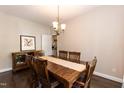 Formal dining room with hardwood floors, traditional lighting, and wooden furniture set at 5609 Barham Ct, Raleigh, NC 27613