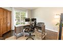 Bright home office with large window, hardwood floors and desk setup, great for remote work at 5609 Barham Ct, Raleigh, NC 27613