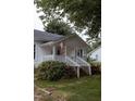 Close up of the inviting front porch with American flag at 6 1St St, Franklinton, NC 27525