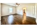 Open-concept living room featuring gleaming hardwood floors and access to the kitchen at 6 First St, Franklinton, NC 27525