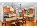 Gourmet kitchen with stainless steel appliances, granite countertops, and a central island with seating at 605 Bear Tree Crk, Chapel Hill, NC 27517