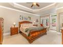 Serene bedroom with a tray ceiling, a king-sized bed, and access to an outdoor patio at 605 Bear Tree Crk, Chapel Hill, NC 27517