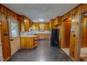 Kitchen featuring wood cabinets, black appliances, linoleum floor, and natural light at 623 Chambers Rd, Rougemont, NC 27572