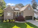 Beautiful brick home featuring a lush green lawn and an attached garage at 6648 Mafolie Ct, Raleigh, NC 27613