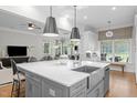 Spacious kitchen with a large center island, stylish pendant lighting, and stainless steel appliances at 6648 Mafolie Ct, Raleigh, NC 27613