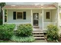 Inviting front porch with wooden steps and lovely shrubbery at 6685 English Ivy Ln, Raleigh, NC 27615