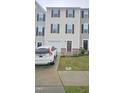 Townhome exterior featuring a driveway, garage, and well-maintained lawn at 904 Romeria Dr, Durham, NC 27713